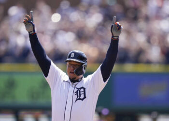 Detroit Tigers designated hitter Miguel Cabrera reacts on first base after his 3,000th career hit during the first inning of the first baseball game of a doubleheader against the Colorado Rockies, Saturday, April 23, 2022, in Detroit. (AP Photo/Carlos Osorio)